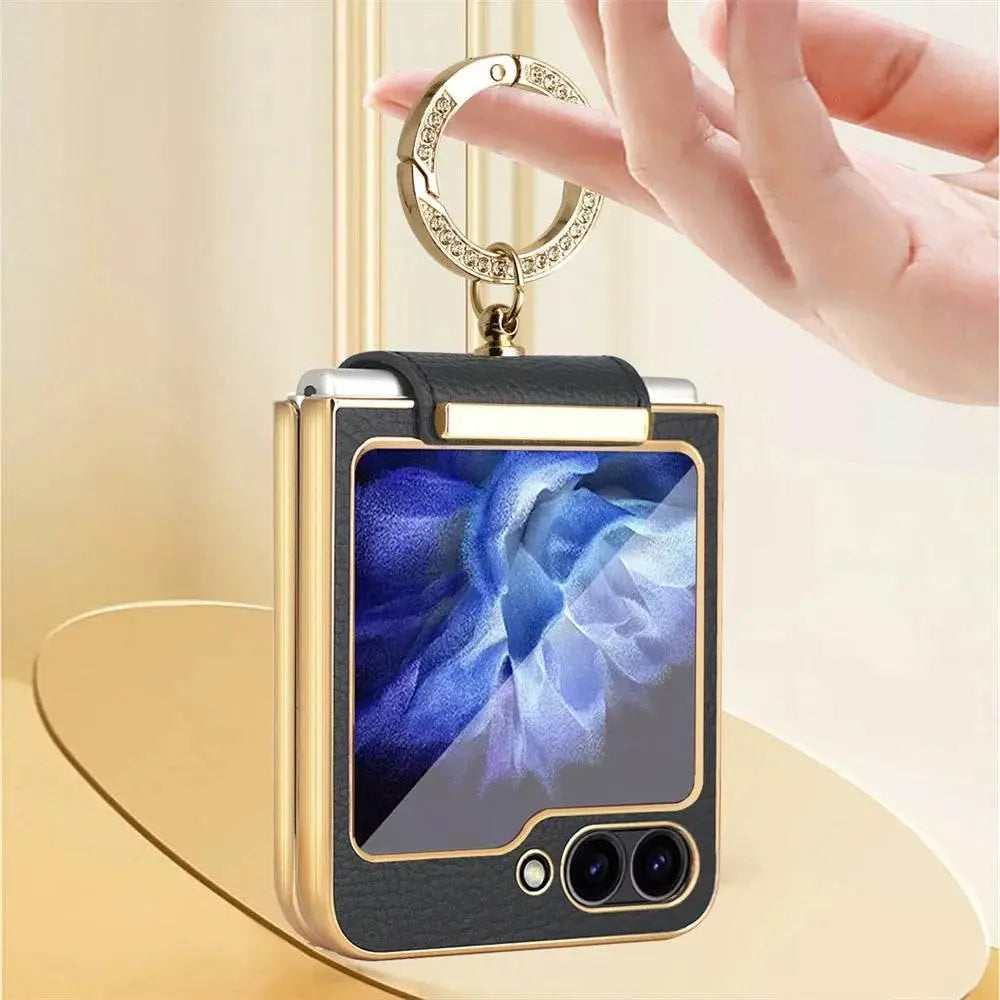 Black and gold protective case with keychain ring for foldable smartphone featuring dual rear cameras
