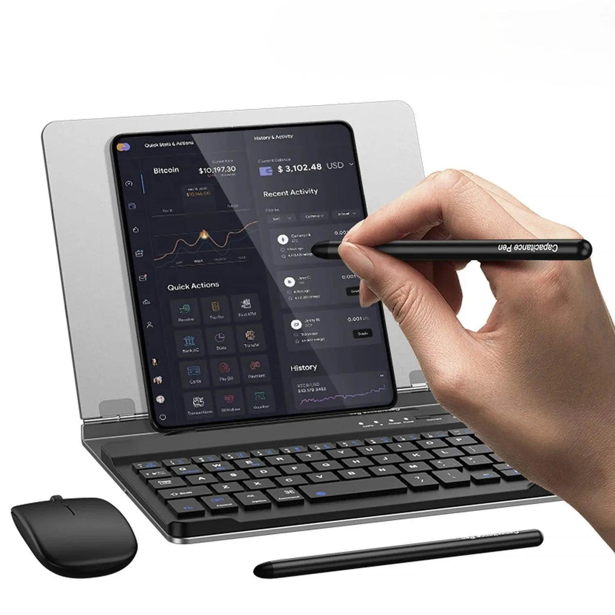 Hand holding black capacitive pen writing on a tablet with Bitcoin financial dashboard, wireless keyboard and mouse